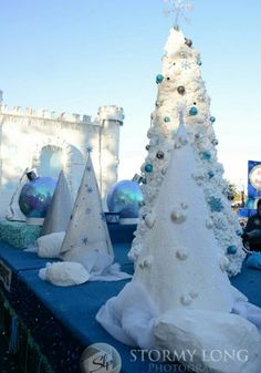 white christmas trees on display at an outdoor event