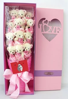 a pink box filled with lots of white teddy bears