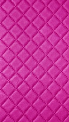 a close up view of a pink quilted material