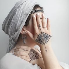 a woman with tattoos covering her face