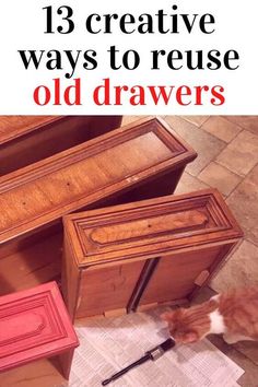 an orange and white cat sitting on top of a wooden dresser next to a red drawer