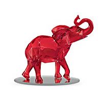 a red elephant figurine sitting on top of a glass plate with the words collection written below it