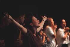 a group of people standing and clapping together