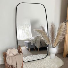 a large mirror sitting on top of a white rug