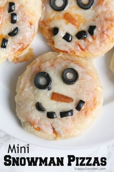 mini snowman pizzas on a white plate