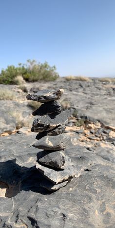 a stack of rocks sitting on top of a rocky hillside