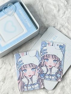 two coasters with anime characters on them next to an open box and white fur