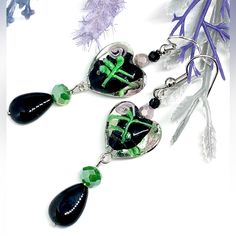 Sweetheart Earrings Pair Black/Clear Lampwork Glass Hearts (14mm X 16mm) With Lavender Purple And Green Floral Detail, With Smooth Black Onyx Teardrops. Grass Green And Lavender Crystal And Petite Black Garnet Stone Bead Accents. Length Including Silver Tone Hooks Approx 2.5”. Black Heart-shaped Drop Earrings For Gift, Black Heart Drop Earrings For Gift, Black Heart Earrings As A Gift, Black Heart Earrings For Pierced Ears As Gift, Handmade Black Dangle Heart Earrings, Handmade Black Heart Dangle Earrings, Black Earrings With Heart Charm For Gift, Handmade Black Heart Earrings, Black Heart Charm Earrings As Gift