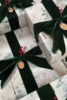 several wrapped presents with green bows and red berries