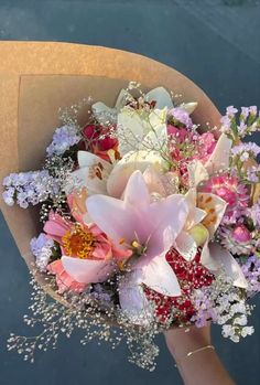 a person holding a bouquet of flowers in their hand