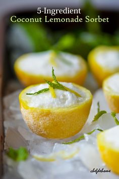 some lemons are sitting on ice with green leaves around them and the words 5 ingredient coconut lemonade sorbet