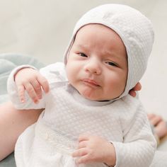 Handmade in the USA This vintage inspired boys baby bonnet is the perfect finishing touch to his take home outfit. Made with our soft quilted cotton in white, it is trimmed in light blue linen so it matches his Harrison newborn gown, yet is simply styled for any coming home outfit. Blue linen ties under the chin allow for a comfortable fit. An adorable traditional baby bonnet to keep your newborn baby warm and styled. 100% white quilted cotton Light blue linen trim Fitted White Bonnet For Baptism, White Fitted Bonnet For Baptism, White Cotton Bonnet For Baptism, Boy Bonnet, Newborn Bonnet, Newborn Gown, Baby Bonnets, Take Home Outfit, Baby Bonnet