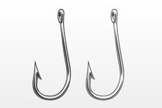 two fishing hooks hanging on the side of a white wall with an arrow pointing up