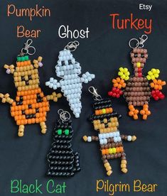 four different beaded key chains with pumpkins, ghost, and black cat