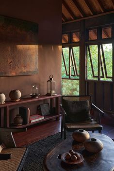 a living room filled with furniture and a painting on the wall