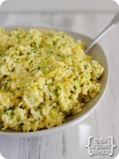 a white bowl filled with rice and broccoli