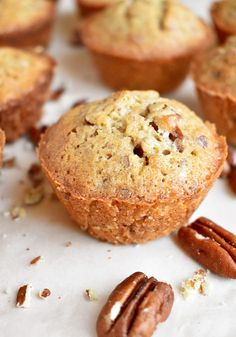 several muffins with pecans scattered around them