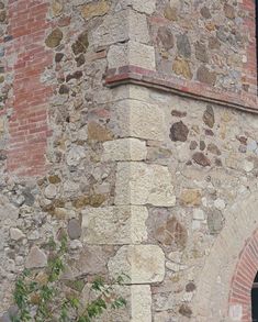 an old brick building with a clock on it's side