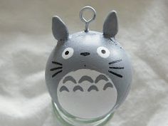 a glass ornament with a totoro face on it