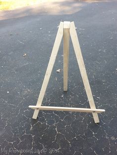 a small wooden easel sitting on the ground