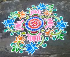 a colorful flower design is painted on the ground with colored chalk and watercolors