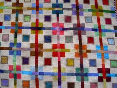 a colorful quilt with squares and lines on it