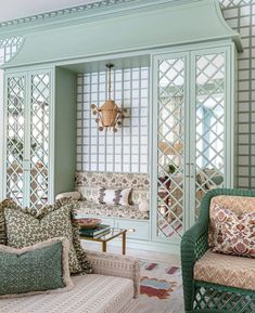 a living room filled with furniture and green walls