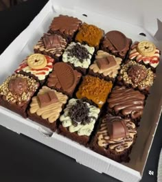 a box filled with lots of different types of chocolates on top of each other