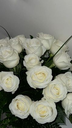 a bunch of white roses in a vase