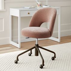 a pink office chair sitting on top of a white rug in front of a desk