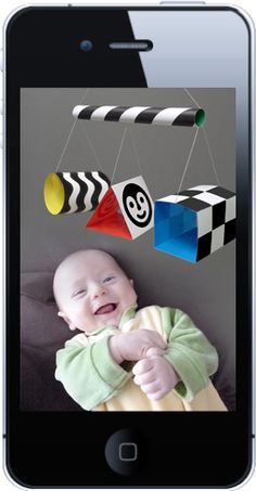 the baby mobile is being displayed on the web page for this photo, and it's made out of construction paper