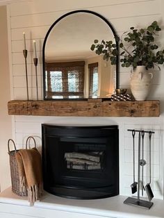 a fireplace with a mirror above it