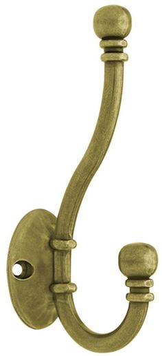 an old fashioned brass hook on a white background