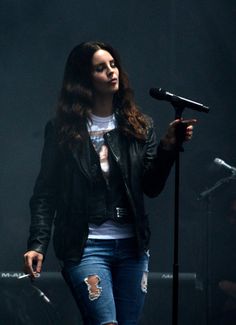 a woman standing in front of a microphone