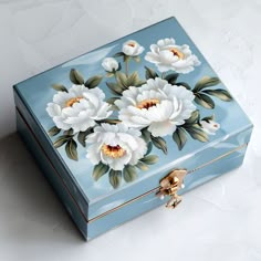 a blue box with white flowers painted on it