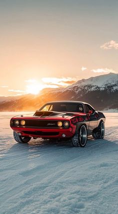 a red and black car parked in the snow