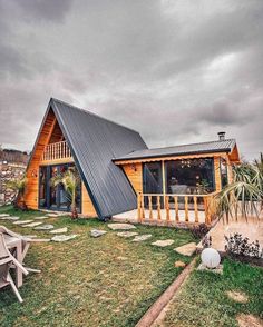 a small wooden house with a metal roof