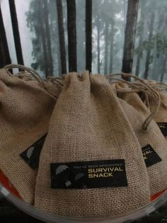 three burlock bags sitting on top of each other in front of some trees