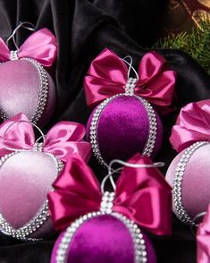 pink and purple ornaments with bows on them