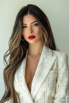 a woman with long brown hair wearing a white jacket and red lipstick on her lips