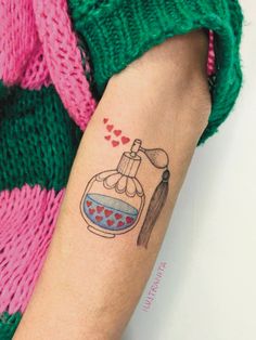 a woman's arm with a tattoo on it that has a flask in it