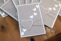 five cards with hearts on them sitting on a table