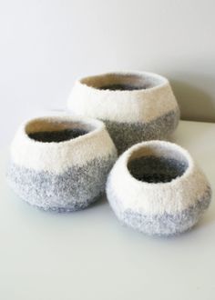 three gray and white slippers sitting on top of a table