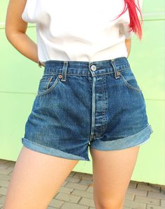 Vintage 501 Levi's denim shorts in blue. High rise. Button fly. Front & back pockets. Raw hem. UK 14-16 / EU 42-44 Actual measurements - 33"(84cm) waist - 40"(102cm) hips - 11.5"(29 cm) outer leg - 11.5"(29cm) rise. Material - Denim. Condition - Excellent. Handpicked, repaired and ready to wear. This is an original vintage item, not new and minor signs of wear & age are expected, we will highlight any major flaws. Model is a UK 8 and is 5'6" tall Vintage Levi's Jean Shorts, Classic High-waisted Jean Shorts For Summer, Levi's High Waist Vintage Shorts, Vintage Levi's Short Bottoms, Classic Levi's Medium Wash Jean Shorts, Vintage Levi's Short Length Jeans, Vintage Levi's Summer Shorts, Vintage Levi's High Rise Jean Shorts, Levi's Vintage High Rise Shorts