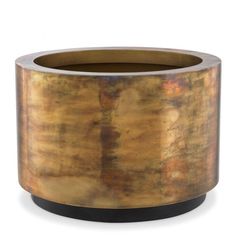 a round metal container with a black base and gold pattered paint on the outside