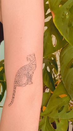 a small tattoo on the arm of a woman's arm with a cheetah