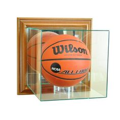 a basketball in a glass case with the word wilson on it's front and bottom