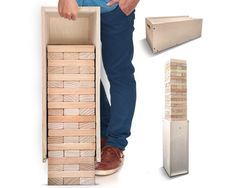 a man standing next to a stack of wooden blocks