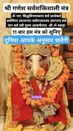 an elephant statue sitting on top of a table next to a wooden box filled with flowers