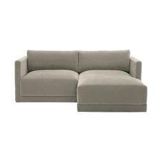 a large gray couch sitting on top of a white floor